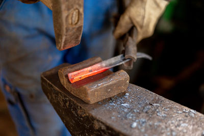 Close up view of heated metal and anvil. the blacksmith in the production process of metal products