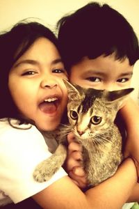 Portrait of cute boy with kitten