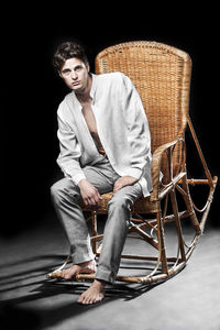 Portrait of young man sitting on chair