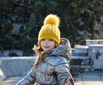 Portrait of smiling boy standing on steps