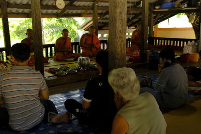 Rear view of people sitting at table