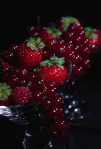 Close-up of strawberries on table against black background