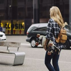 Rear view of a woman standing in city