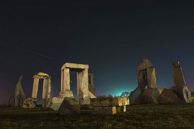 Old ruins of building against sky at night