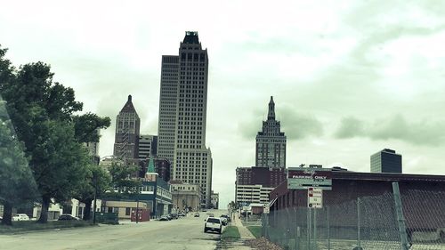 Modern buildings against cloudy sky