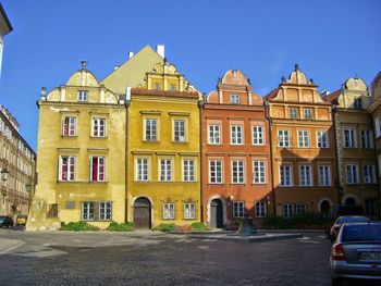 Facade of houses against blue sky