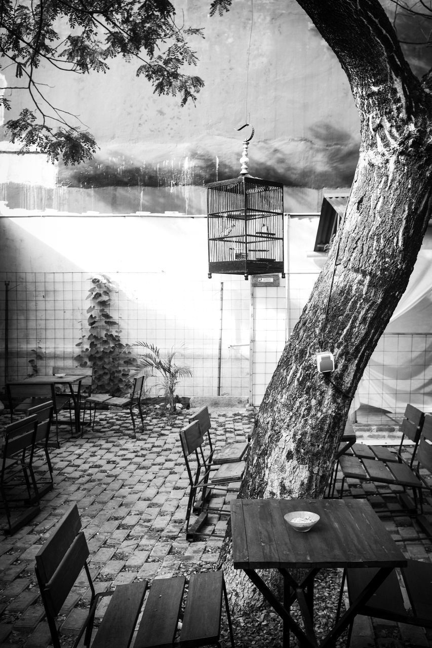 REFLECTION OF MAN ON BENCH IN GLASS BUILDING