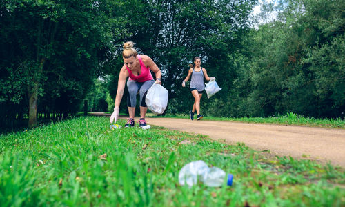 Women picking garbage on road