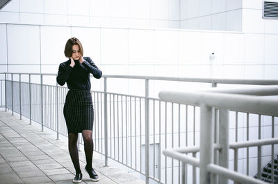 Young woman walking on elevated walkway