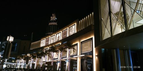 Low angle view of illuminated building against sky at night