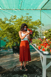 Woman looking at flowering plants