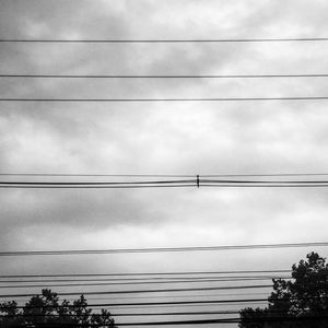 Low angle view of electricity pylon against sky