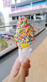 Close-up of hand holding ice cream cone