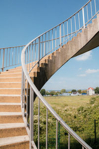 View of outdoor winding staircase against sky
