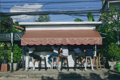 Rear view of people walking on building