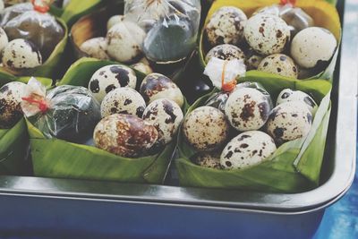 Close up quail eggs boiled eat with soya sauce in banana leaf bowl for sale