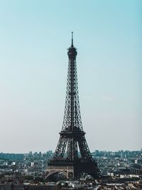 Eiffel tower in city against clear sky