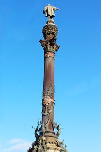 Low angle view of statue against blue sky