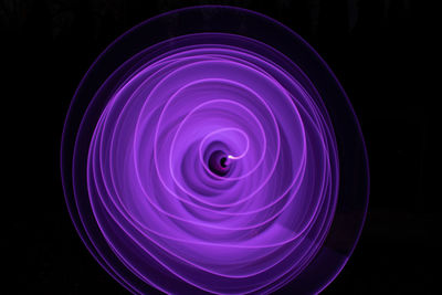 Close-up of illuminated lights against black background