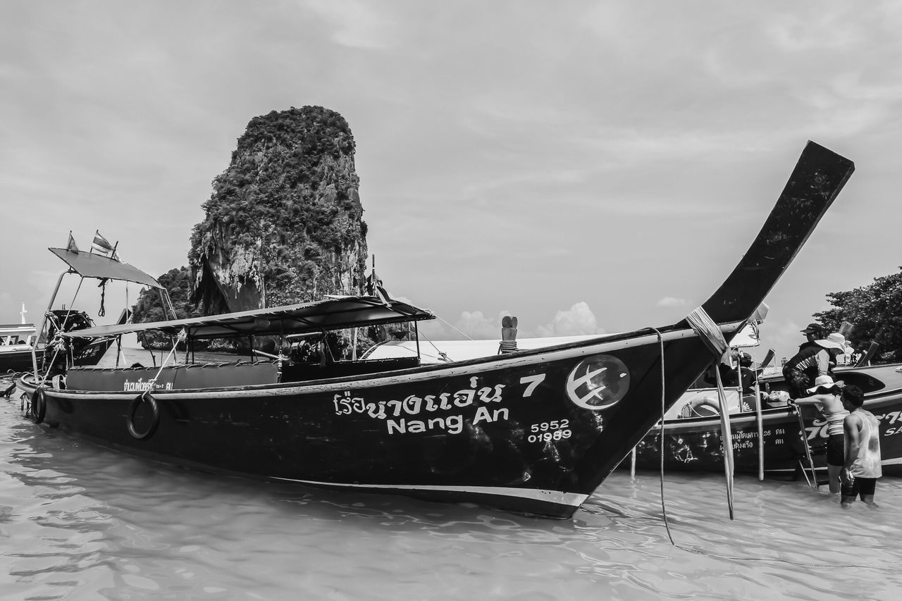 nautical vessel, transportation, mode of transport, text, sky, day, outdoors, sea, nature, moored, water, longtail boat, no people