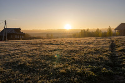 Scenic view of field against sky during sunset