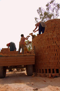 Man working against clear sky