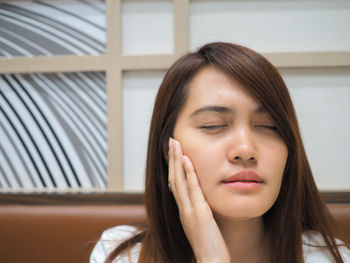 Beautiful woman suffering from toothache at home