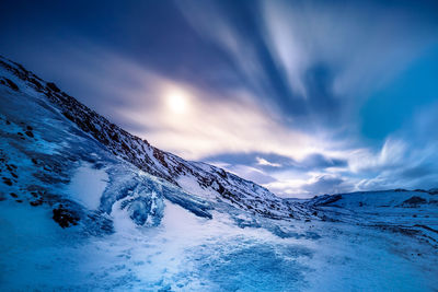 Scenic view of snowcapped mountains against sky