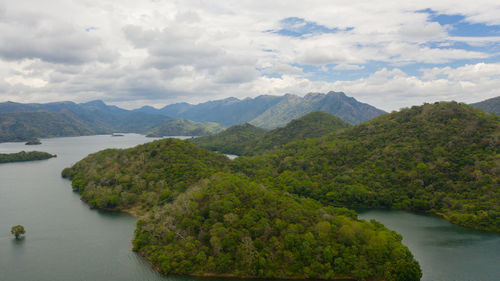 Tropical landscape a lake surrounded by mountains and jungle. randenigala reservoir.