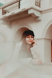 Portrait of young woman wearing hat