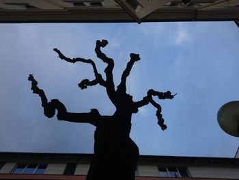 Low angle view of silhouette statue