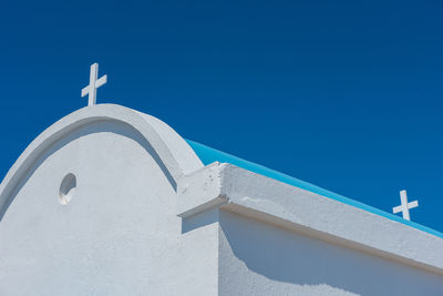 Traditional greek white chapel with a blue roof on the seaside. agioi anargyroi chapel, cyprus