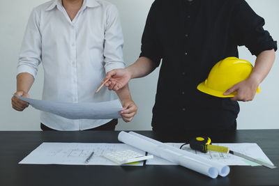 Midsection of a man working on table