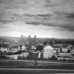 Buildings against cloudy sky