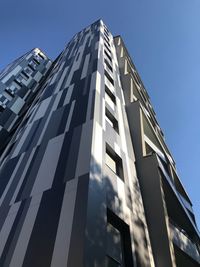 Low angle view of modern building against clear blue sky