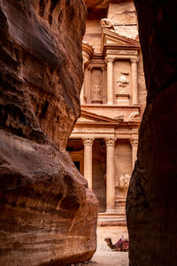 Low angle view of historical building seen through rock formations