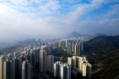 Aerial view of buildings in city against sky