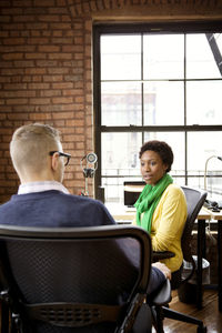 Colleagues discussing in office