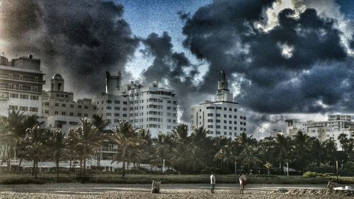 Buildings against cloudy sky