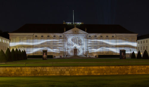 Illuminated building against sky at night