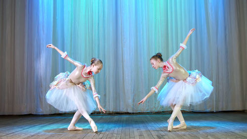 Ballet rehearsal, on the stage of the old theater hall. young ballerinas in elegant dresses