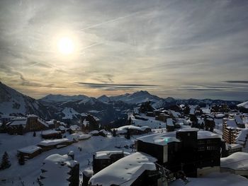 Scenic view of town against sky during winter