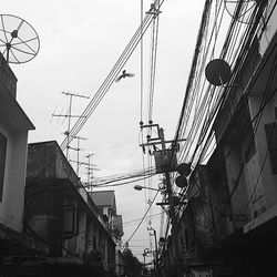 Low angle view of power lines against sky