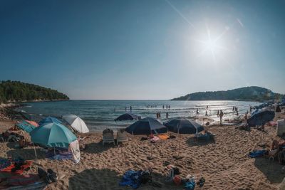 Scenic view of beach against sky at sunset