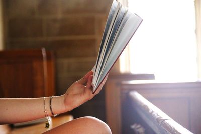 Close-up of woman's hand with book