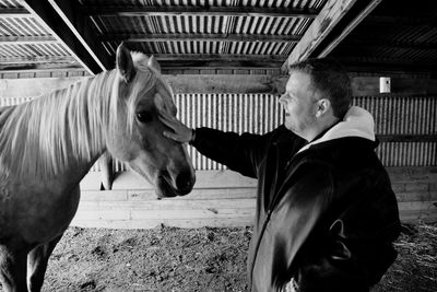 Full length of man standing in stable