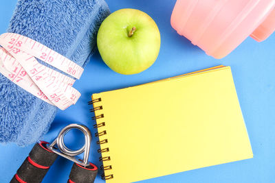 High angle view of apple and book on table