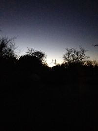 Silhouette trees against sky during sunset