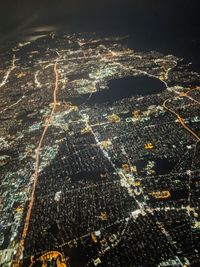 Aerial view of illuminated buildings in city at night