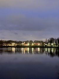 Scenic view of lake against sky at night